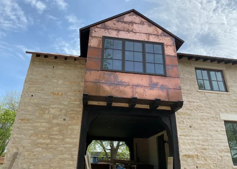 Copper metal panel facade on a stone building for Metal Roof Coating in Rapid Valley