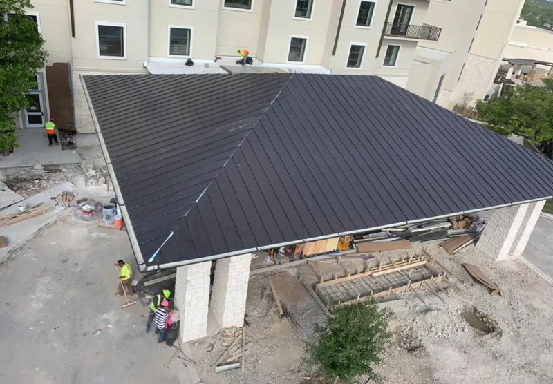 Metal roofing installation team working on a commercial building in Rapid Valley